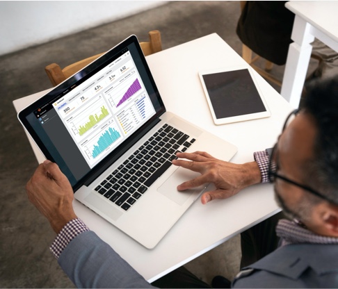 A middle-aged man reviews graphs related to an education data management event he’s attending.